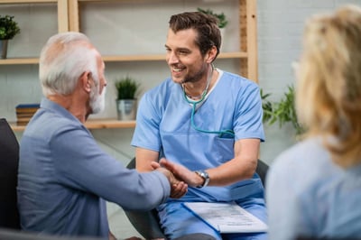 Happy-healthcare-worker-and-mature-patient-handshaking-during-a-home-visit.-1152840546_6720x4480