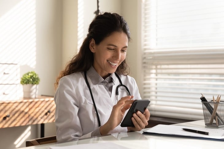 Smiling-female-doctor-use-smartphone-in-hospital-1293277479_6720x4480-1