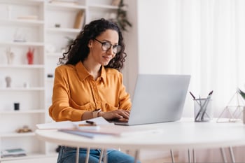 female-european-adult-indoor-working-online-with-laptop-print